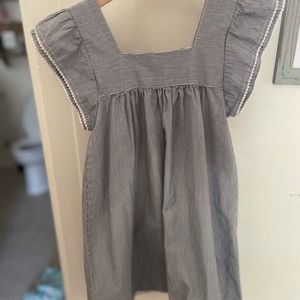 Grey and white striped cotton girls dress with polka dot piping.